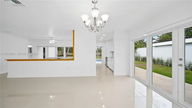 a view of kitchen with refrigerator and window