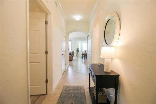 a hallway with white cabinets and white appliances