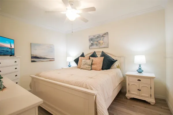 a large bed sitting in a bedroom next to a lamp