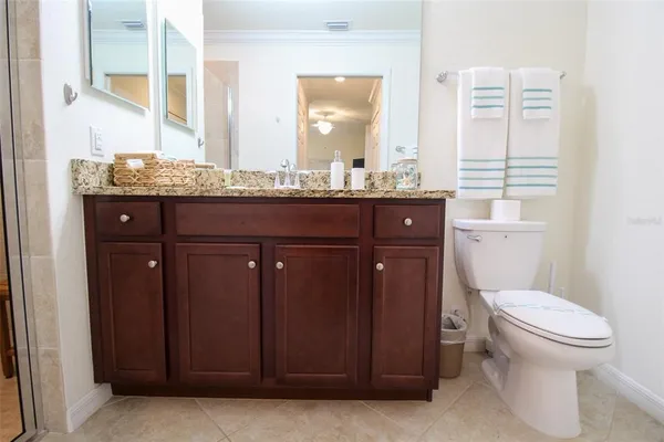 a bathroom with a granite countertop shower and a sink