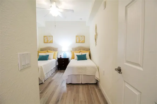 a bedroom with a bed and wooden floor