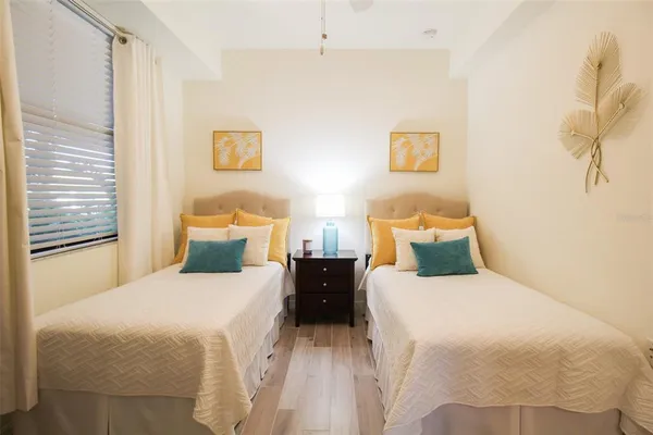 a view of a bedroom with wooden floor cabinet and front door