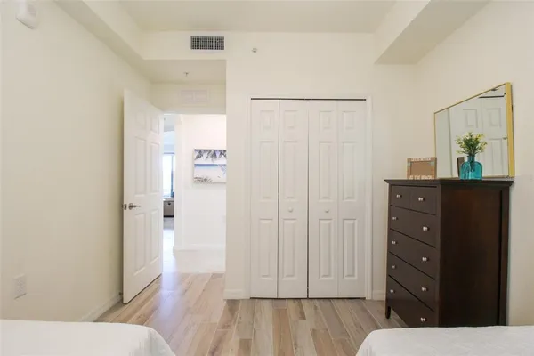 a bathroom with a granite countertop toilet a sink and a mirror