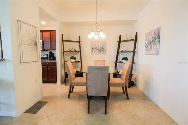 a view of kitchen with furniture and refrigerator