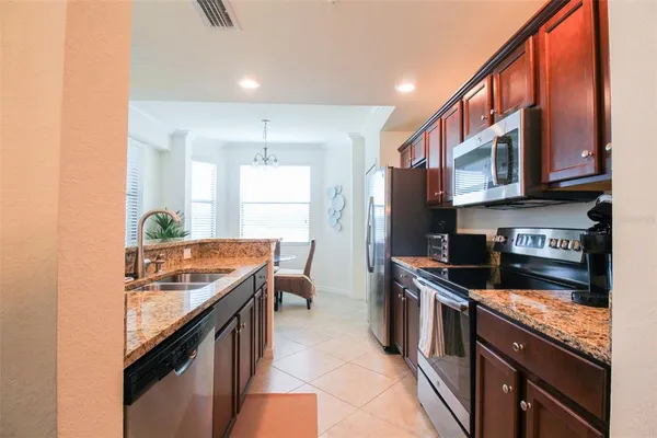a kitchen with stainless steel appliances granite countertop a stove a microwave and a refrigerator
