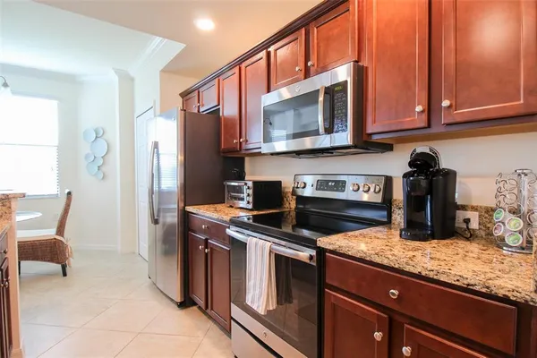 a kitchen with a sink stove and cabinets