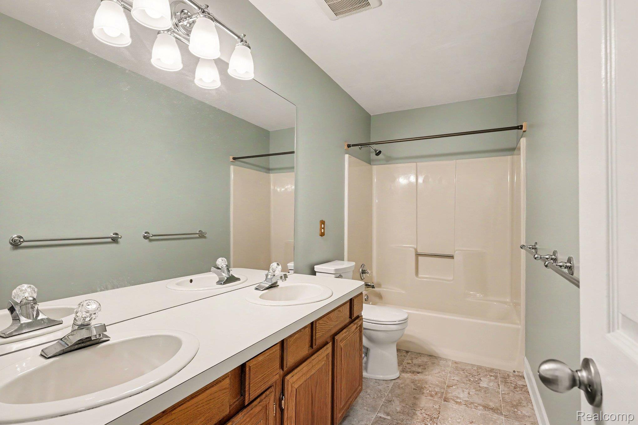 1692 Ridgecrest Rochester, MI 48306 - Photo 20 of 31 Double vanity with two integrated sinks, wood-finish cabinetry, and a full-width mirror