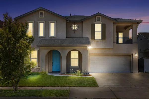 a front view of a house with a yard