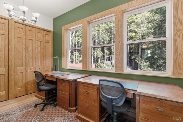 a dining room with a window and chairs