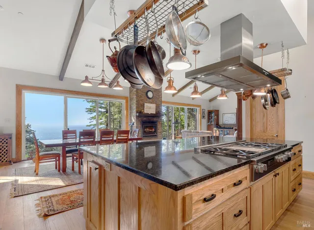 a kitchen with stainless steel appliances granite countertop a stove and a white cabinets