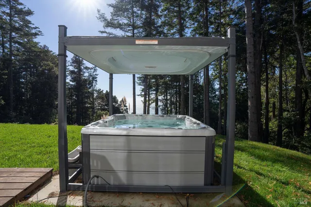 a view of a backyard with plants and outdoor seating