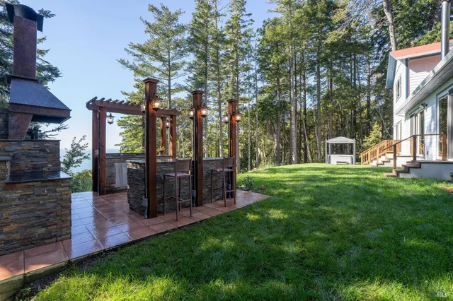 a kitchen with stainless steel appliances granite countertop a sink a stove and a refrigerator