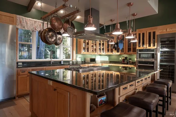 a kitchen with stainless steel appliances granite countertop a stove and a sink