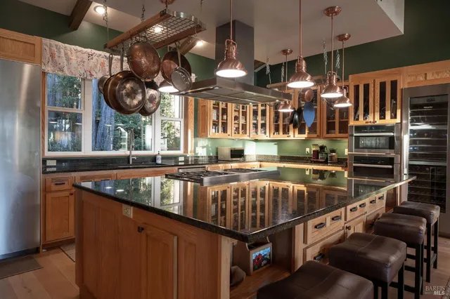 a kitchen with stainless steel appliances granite countertop a stove and a sink