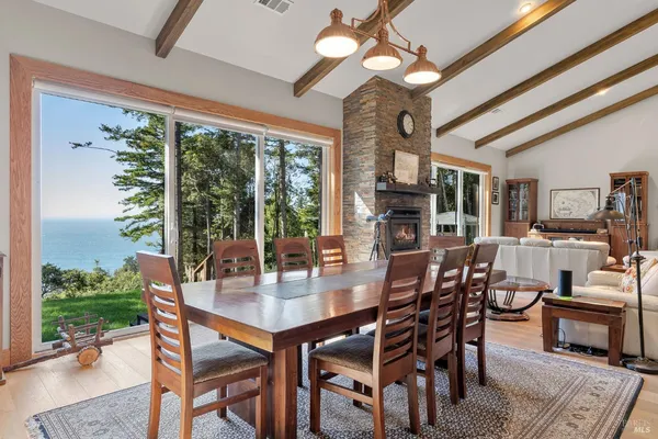 a dining room with furniture window and wooden floor