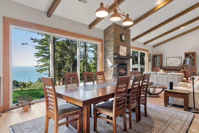 a dining room with furniture window and wooden floor