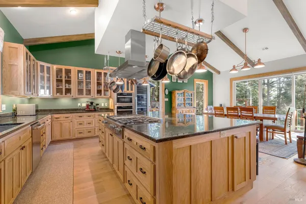 a kitchen with stainless steel appliances granite countertop a sink and cabinets