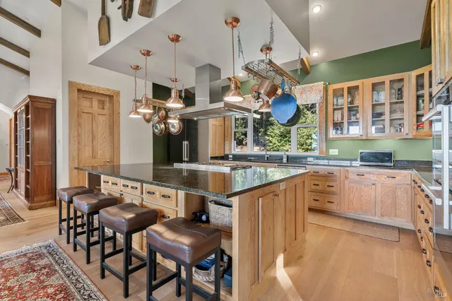 a kitchen with stainless steel appliances granite countertop a sink and cabinets