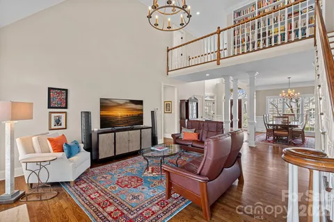 a living room with furniture a rug and a chandelier
