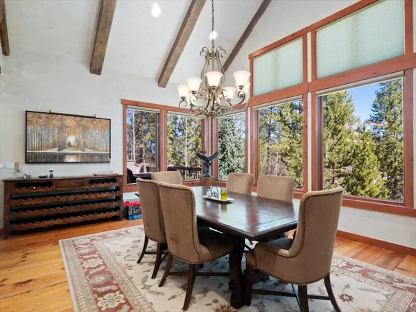 a view of a dining room with furniture wooden floor and chandelier