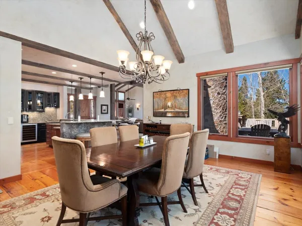 a dining room with furniture a rug and wooden floor