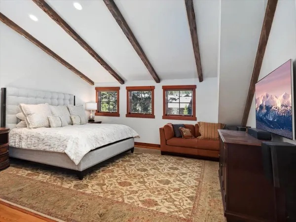 a bedroom with furniture and a flat screen tv