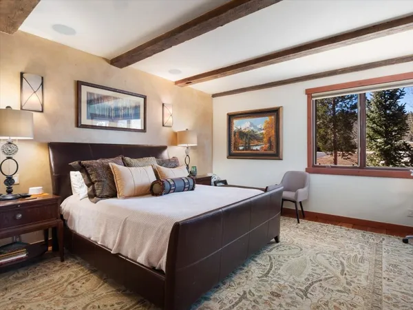 a bedroom with a large bed and a window