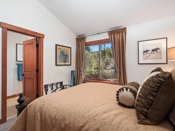 a bed sitting in a bedroom next to a window