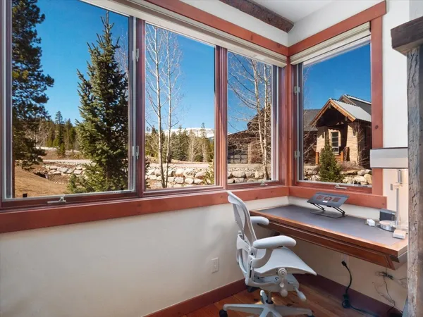 a room with pool table and windows