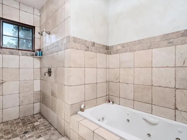 a bathroom with a bathtub and shower