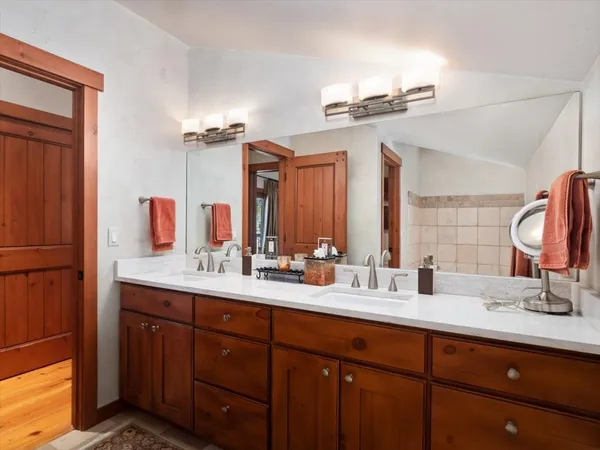 a bathroom with a double vanity sink and a mirror