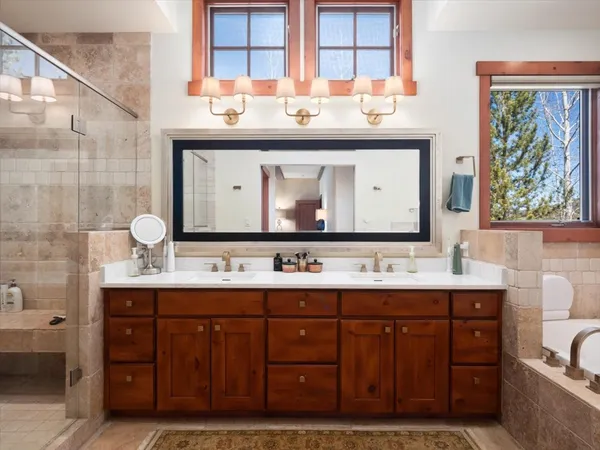 a bathroom with a double vanity sink and a mirror