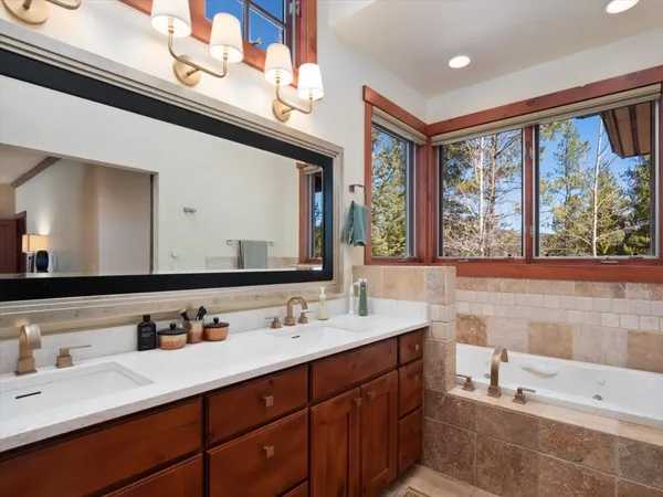 a bathroom with a double vanity sink and a large mirror