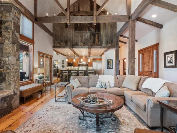 a living room with furniture a rug and a chandelier