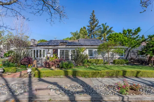 a front view of a house with a garden