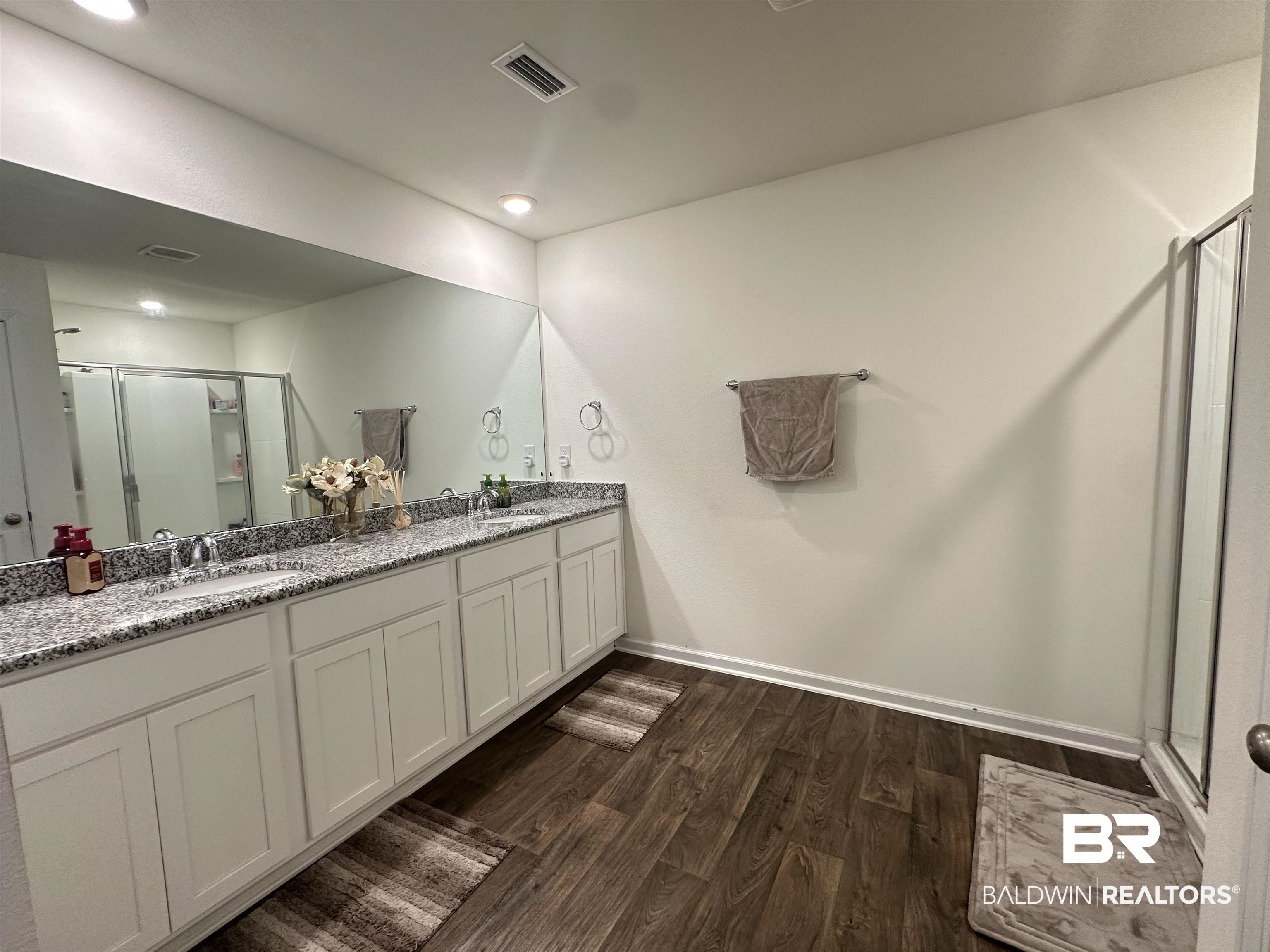23792 Unbridled Loop Daphne, AL 36526 - Photo 14 of 36 Full bathroom with a stall shower, dark wood-style flooring, and double vanity