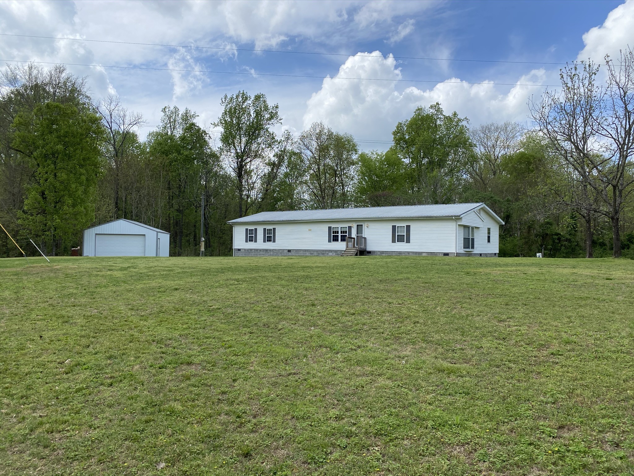 1340 Throneberry Road Normandy, TN 37360 - Photo 1 of 37 a front view of house with yard and trees in the background