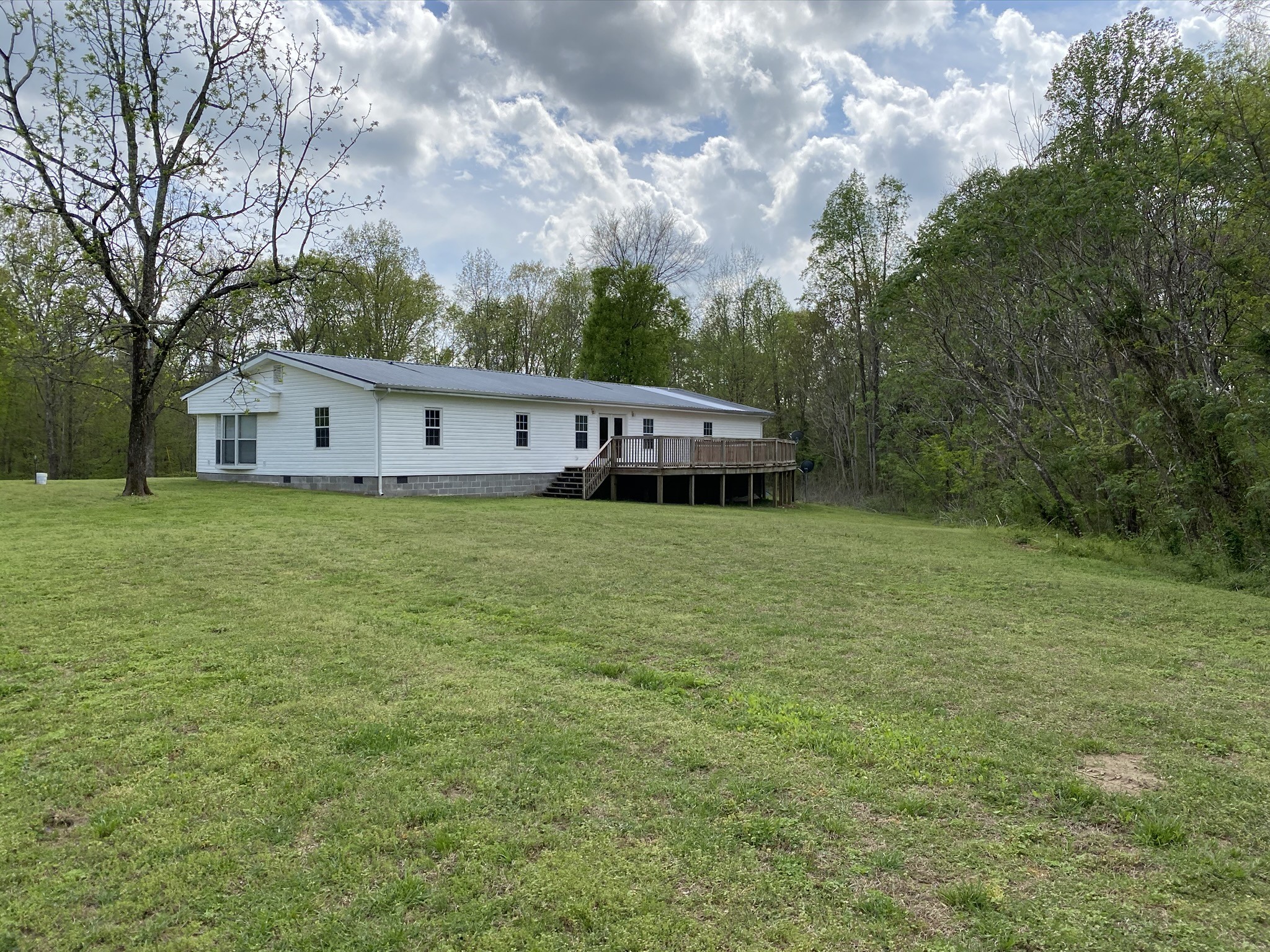 1340 Throneberry Road Normandy, TN 37360 - Photo 3 of 37 a view of a house with a big yard and large trees
