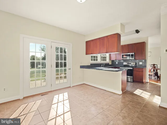 a view of a kitchen with refrigerator stove microwave and cabinets