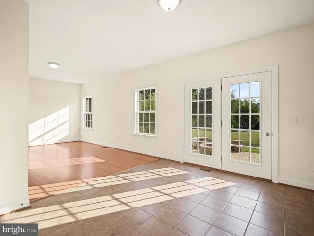 a living room with a bed furniture and a window