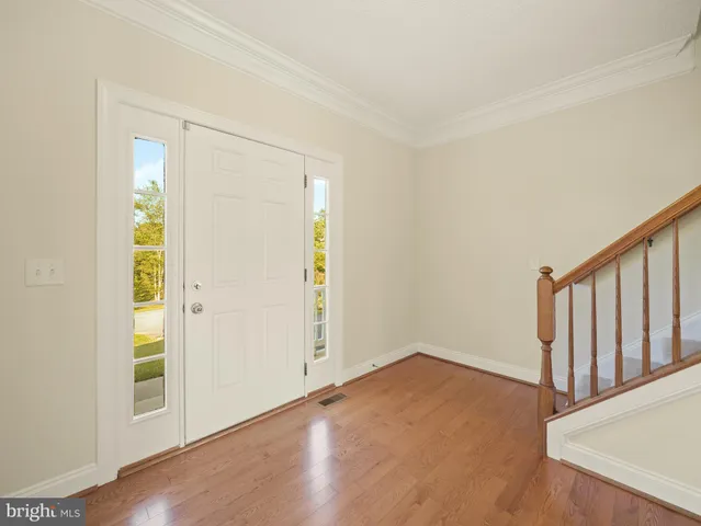 a bedroom with a bed and a chandelier fan