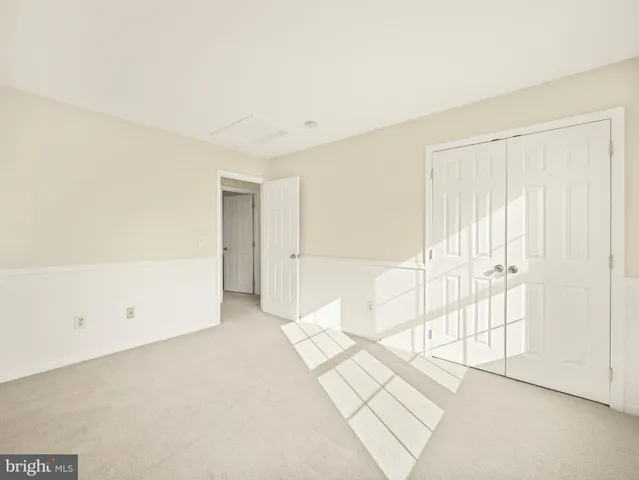 an aerial view of a city with lots of residential buildings ocean and mountain view in back