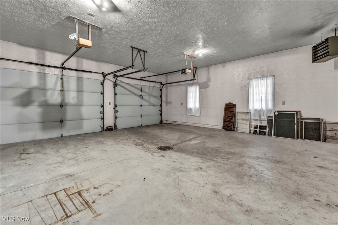 38814 Johnnycake Ridge Road Willoughby, OH 44094 - Photo 43 of 48 Garage featuring a garage door opener