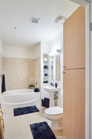 a bathroom with a sink a toilet and tub