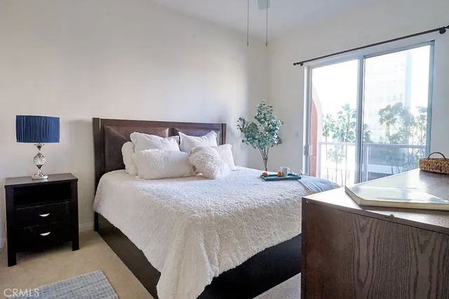 a bedroom with a bed and a potted plant