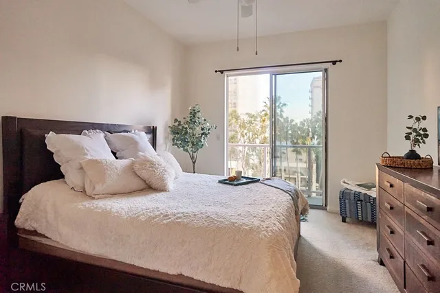 a large bed sitting in a bedroom next to a window