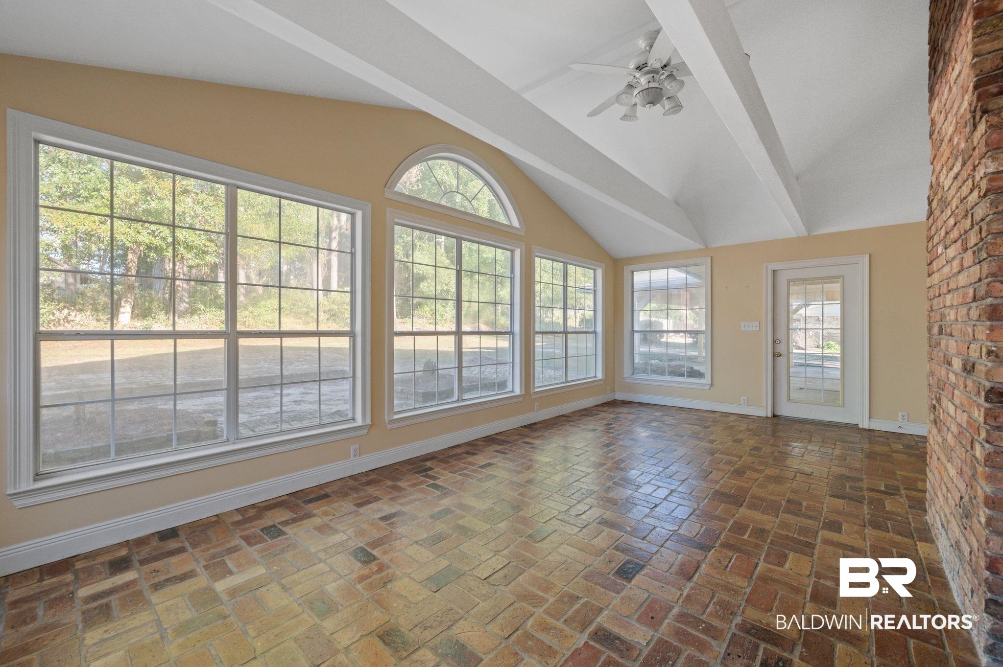 909 Caroline Avenue Daphne, AL 36526 - Photo 19 of 46 Unfurnished sunroom with ceiling fan, plenty of natural light, and lofted ceiling
