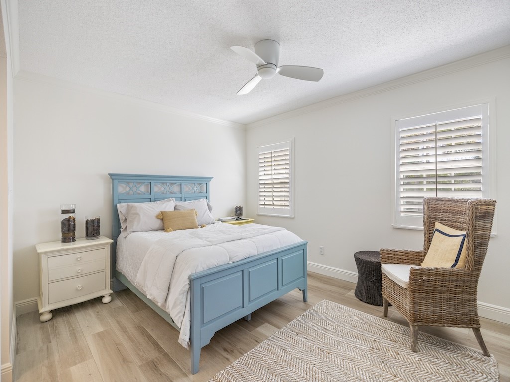 1180 Reef Road, Unit A24 Vero Beach, FL 32963 - Photo 15 of 26 a bedroom with a bed chair and a window