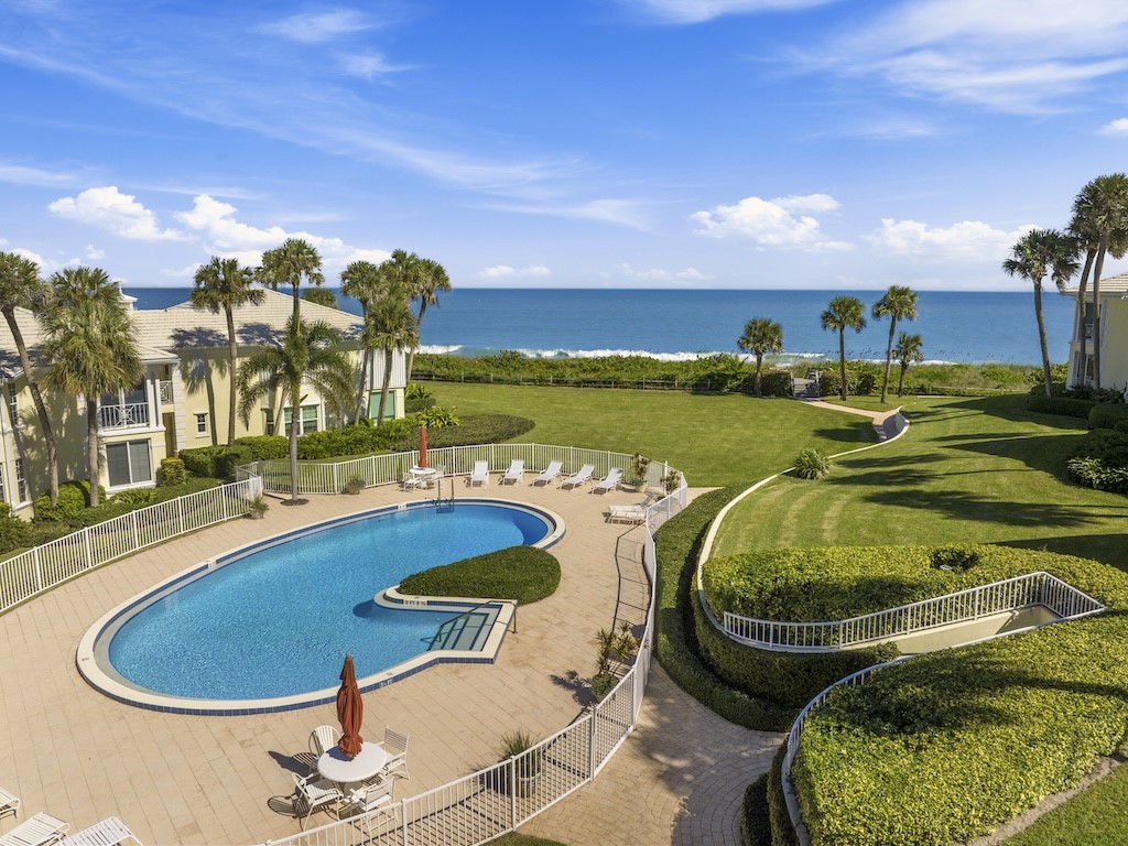 1180 Reef Road, Unit A24 Vero Beach, FL 32963 - Photo 19 of 26 a swimming pool with outdoor seating and yard