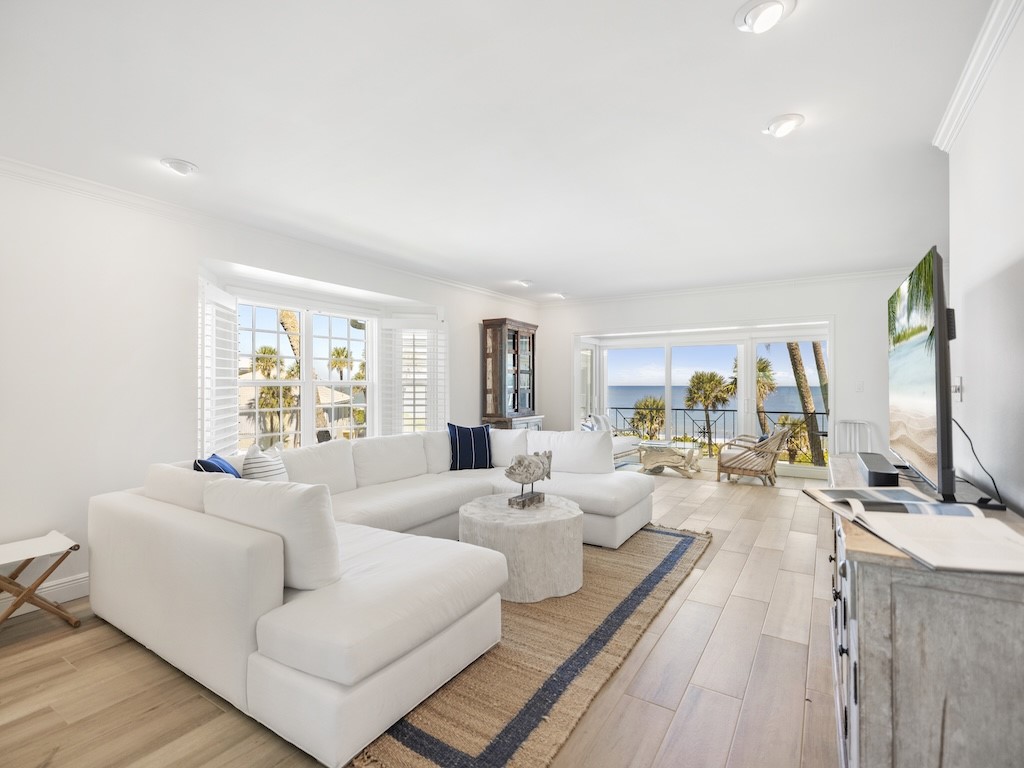 1180 Reef Road, Unit A24 Vero Beach, FL 32963 - Photo 2 of 26 a living room with furniture and a large window